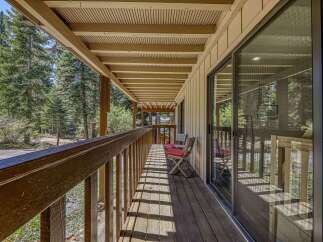 Enjoy the serene mountain setting from this charming covered porch, perfect for morning coffee or evening relaxation.