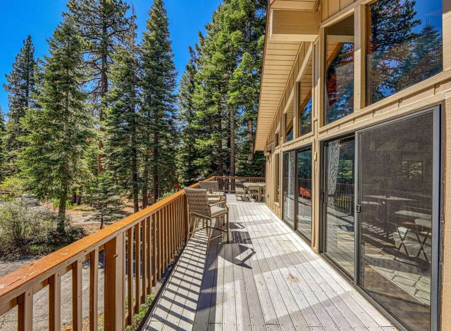 Enjoy the serene mountain setting from this expansive wooden deck, perfect for outdoor living and entertaining.