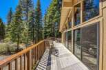 Enjoy the serene mountain setting from this expansive wooden deck, perfect for outdoor living and entertaining.