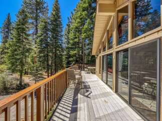 Enjoy the serene mountain setting from this expansive wooden deck, perfect for outdoor living and entertaining.