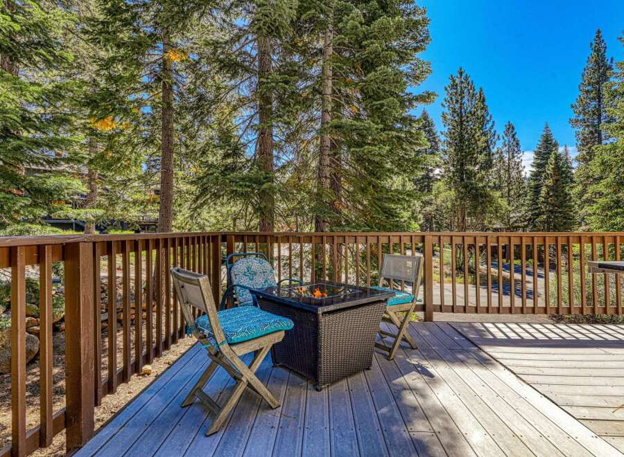 Enjoy the crisp mountain air from this charming deck, complete with a cozy fire pit and comfortable seating.