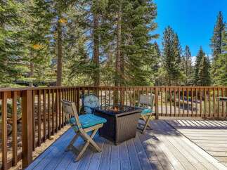 Enjoy the crisp mountain air from this charming deck, complete with a cozy fire pit and comfortable seating.