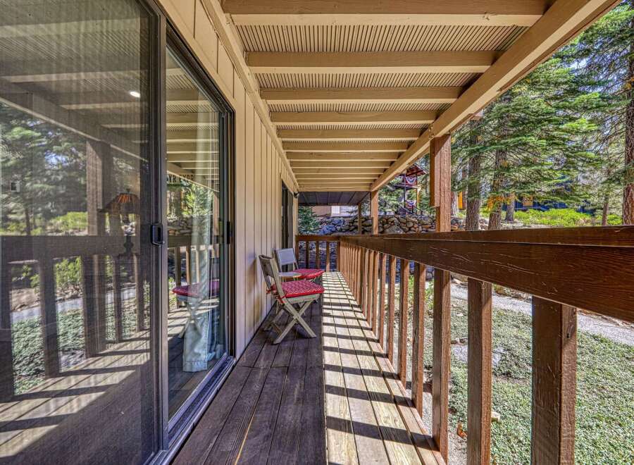 Enjoy the serene mountain setting from this charming covered porch, perfect for morning coffee or evening relaxation.