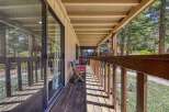 Enjoy the serene mountain setting from this charming covered porch, perfect for morning coffee or evening relaxation.
