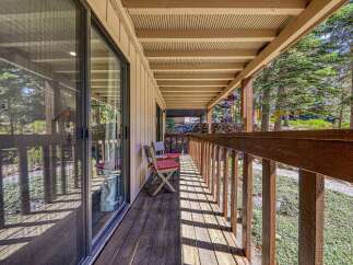 Enjoy the serene mountain setting from this charming covered porch, perfect for morning coffee or evening relaxation.
