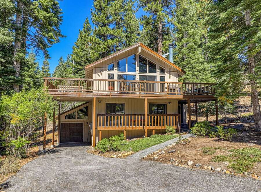 Nestled amidst towering pine trees, this charming multi-level home offers a serene mountain retreat.
