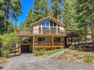 Nestled amidst towering pine trees, this charming multi-level home offers a serene mountain retreat.
