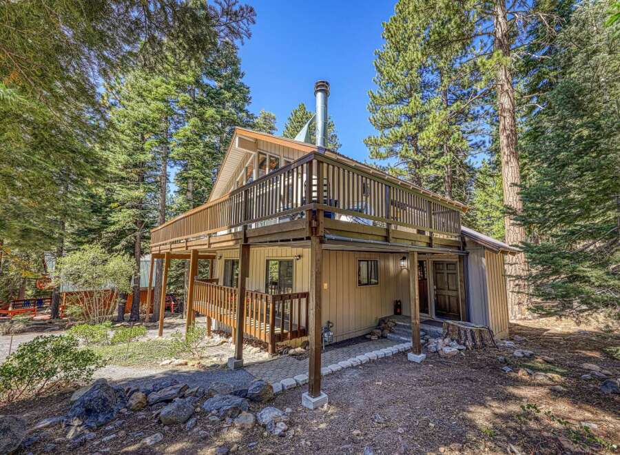 Nestled among tall pine trees, this charming cabin offers a serene mountain retreat.
