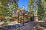 Nestled among tall pine trees, this charming cabin offers a serene mountain retreat.