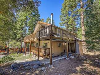 Nestled among tall pine trees, this charming cabin offers a serene mountain retreat.