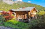 Experience alpine luxury in this charming wooden chalet, featuring a private hot tub perfect for relaxing after a day of adventure.