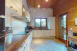 Experience the charm of this mountain retreat kitchen, featuring sleek white cabinetry and warm wooden countertops.
