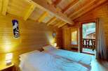 Experience cozy mountain living in this charming wooden cabin bedroom, featuring two comfortable twin beds perfect for a restful night's sleep.