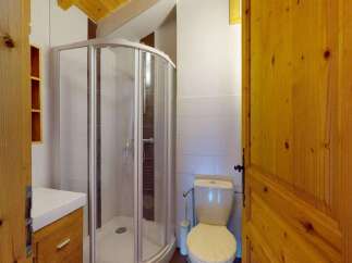 Discover this charming bathroom featuring a modern shower enclosure and a clean white vanity with ample storage.