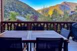 Enjoy breathtaking mountain views from this charming outdoor dining area, perfect for al fresco meals.