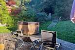 Relax and unwind in this serene backyard oasis, featuring a luxurious wooden hot tub perfect for soaking under the stars.