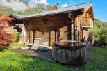Experience ultimate relaxation in this charming wooden chalet, featuring a private hot tub perfect for unwinding after a day of mountain adventures.