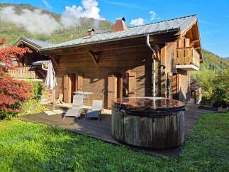 Experience ultimate relaxation in this charming wooden chalet, featuring a private hot tub perfect for unwinding after a day of mountain adventures.