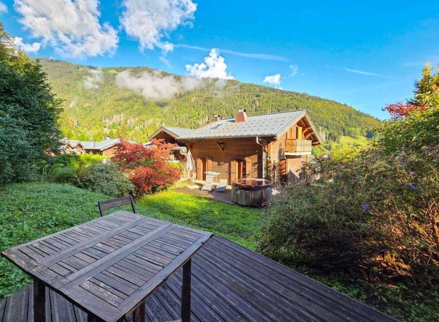 Experience serene mountain living in this charming wooden chalet, complete with a private hot tub perfect for relaxation.
