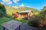 Experience serene mountain living in this charming wooden chalet, complete with a private hot tub perfect for relaxation.