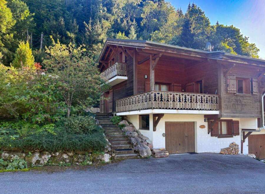Nestled amidst lush greenery and towering trees, this charming wooden chalet offers a serene mountain retreat.