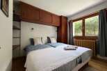 This charming bedroom features two comfortable twin beds with stylish patterned bedding and plush pillows.