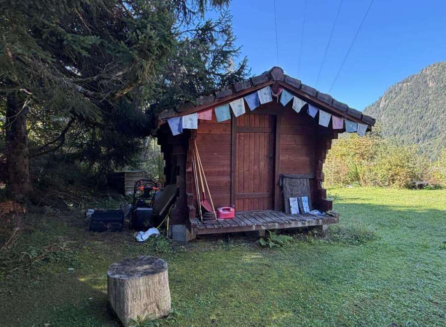 Discover this charming wooden shed, perfect for storage or as a cozy retreat.