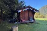 Discover this charming wooden shed, perfect for storage or as a cozy retreat.