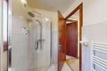 Step into this inviting bathroom featuring a spacious glass-enclosed shower with a modern showerhead, perfect for a refreshing start to your day.