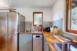 This charming kitchen features a sleek stainless steel refrigerator and a modern dishwasher, perfect for any home chef.