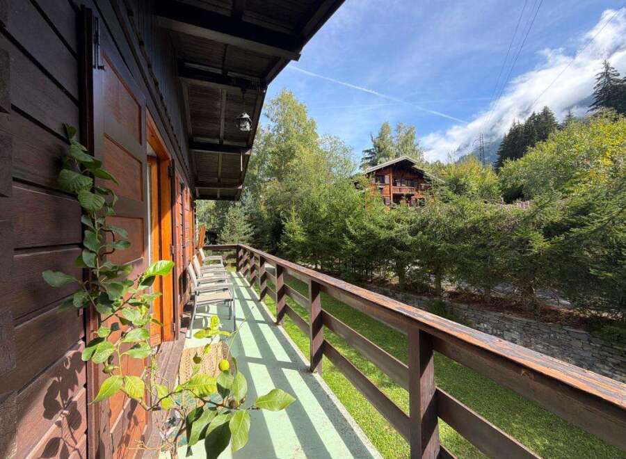 Experience the charm of this rustic wooden cabin, featuring a spacious balcony with stunning forest views.