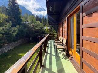 Enjoy breathtaking mountain views from this charming wooden balcony, perfect for morning coffee or evening relaxation.