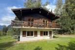 Experience the charm of this rustic wooden chalet, nestled amidst lush greenery and offering breathtaking mountain views.