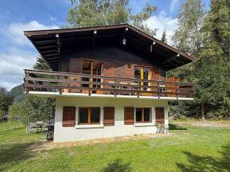 Experience the charm of this rustic wooden chalet, nestled amidst lush greenery and offering breathtaking mountain views.