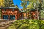 Nestled amidst a vibrant autumn landscape, this stunning wood-sided home offers a warm and inviting ambiance.