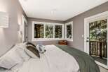 Experience serene living in this cozy bedroom, featuring a comfortable bed adorned with plush pillows and a soft green throw.