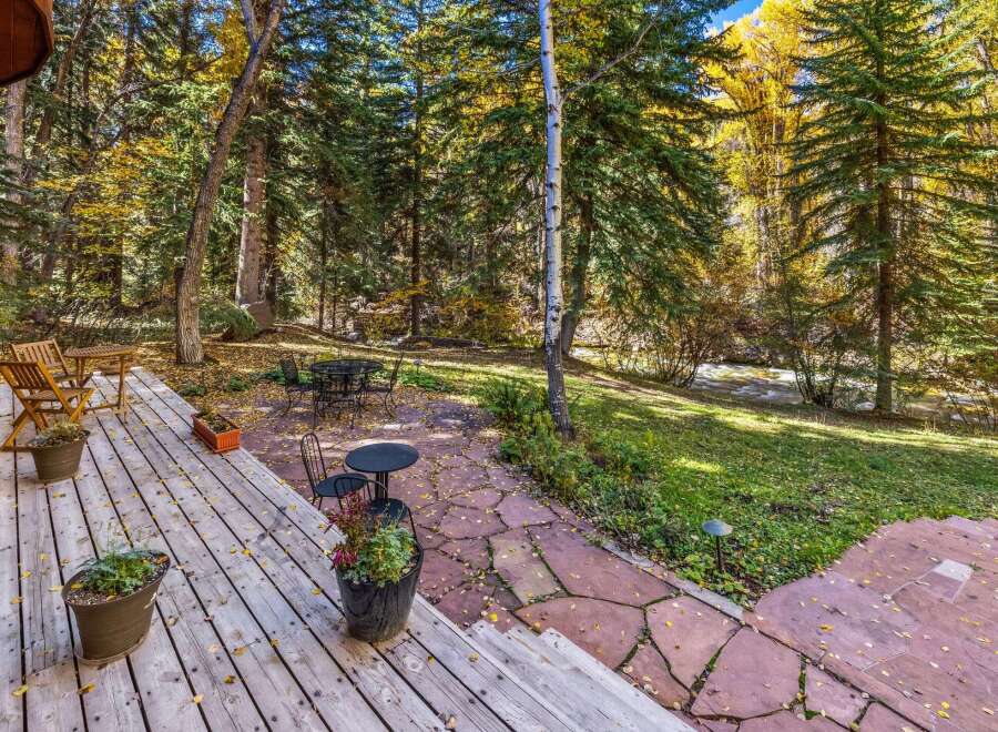 Enjoy the serene beauty of autumn from this charming outdoor living space.
