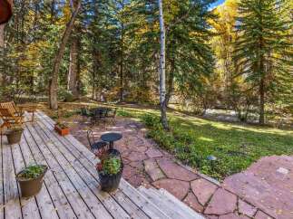 Enjoy the serene beauty of autumn from this charming outdoor living space.
