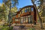 Experience luxury living in this stunning wooden home nestled amidst vibrant autumn foliage.