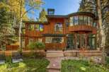 Nestled amidst vibrant autumn foliage, this stunning wooden home offers a serene retreat.