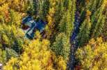 Nestled amidst a vibrant autumn forest, this stunning property offers a unique blend of natural beauty and comfortable living.