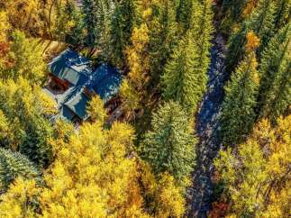 Nestled amidst a vibrant autumn forest, this stunning property offers a unique blend of natural beauty and comfortable living.