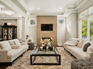 Experience luxury living in this beautifully appointed living room, featuring a modern fireplace with a sleek tile surround and a mounted flat-screen TV.