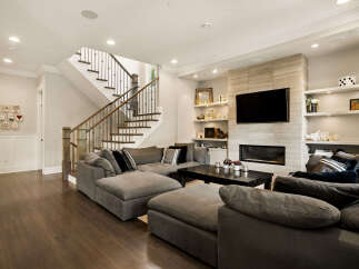 Experience modern living in this spacious living room featuring a large sectional sofa perfect for gatherings.