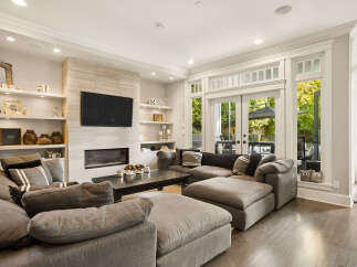 Experience modern living in this stunning living room, featuring a sleek fireplace and a large sectional sofa perfect for gatherings.
