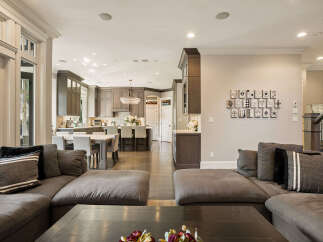 Experience seamless living in this open-concept home featuring a spacious living area flowing into a gourmet kitchen.