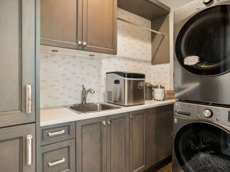 This modern laundry room features a stacked LG washer and dryer, perfect for maximizing space.