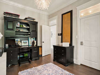 This home office features a classic black hutch desk with ample storage and display space, perfect for organizing your work essentials.