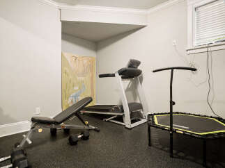 Transform your home into a personal fitness sanctuary with this well-equipped gym space.