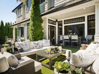 Experience luxurious outdoor living with this stunning patio featuring a spacious sectional sofa and a modern coffee table, perfect for entertaining.
